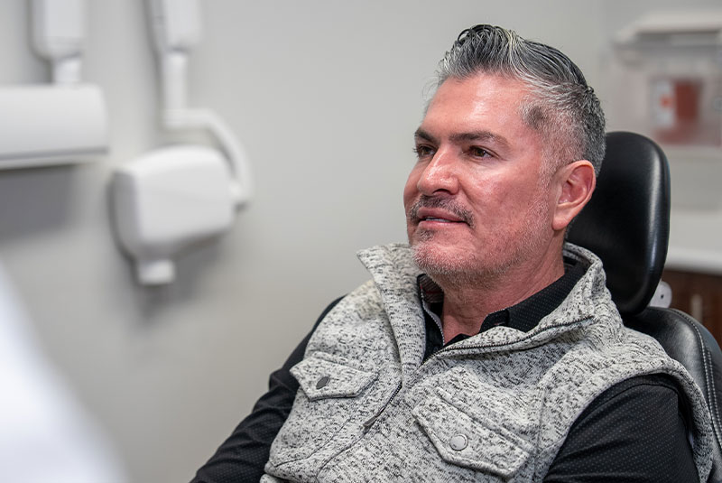 dental implant patient learning about candidacy