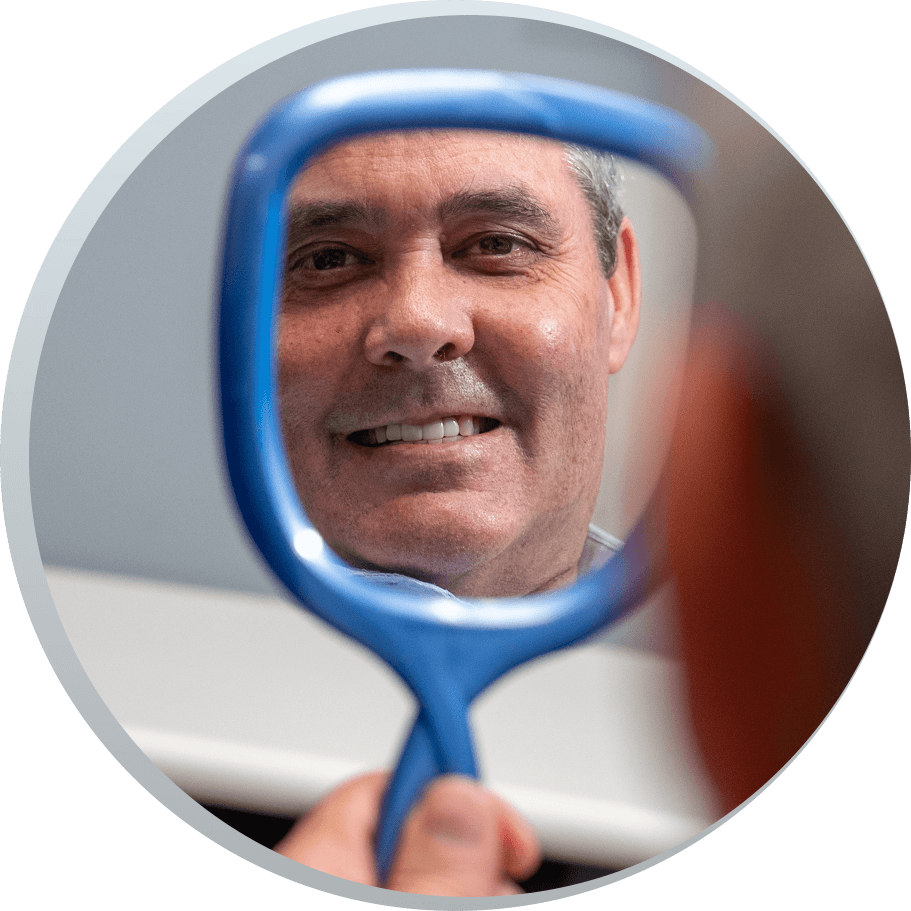 Kim smiling into handhelf mirror