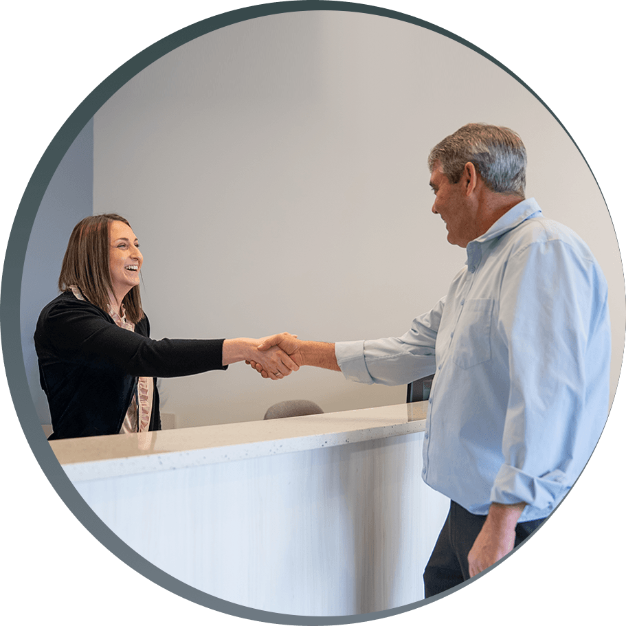 dental patient shaking hands with receptionist