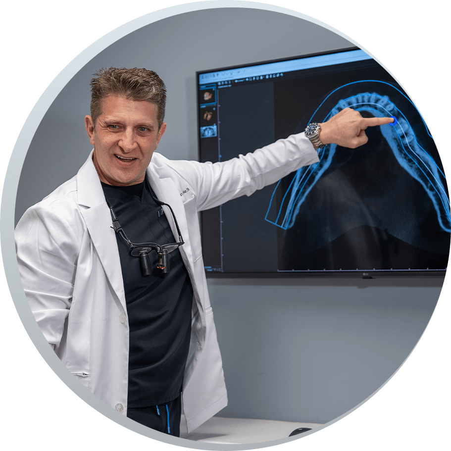 Dr. Justin Tooke pointing at xray on TV screen